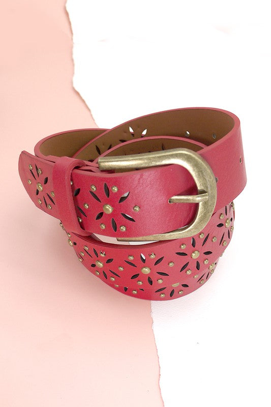 Red belt with gold buckle on a pink background