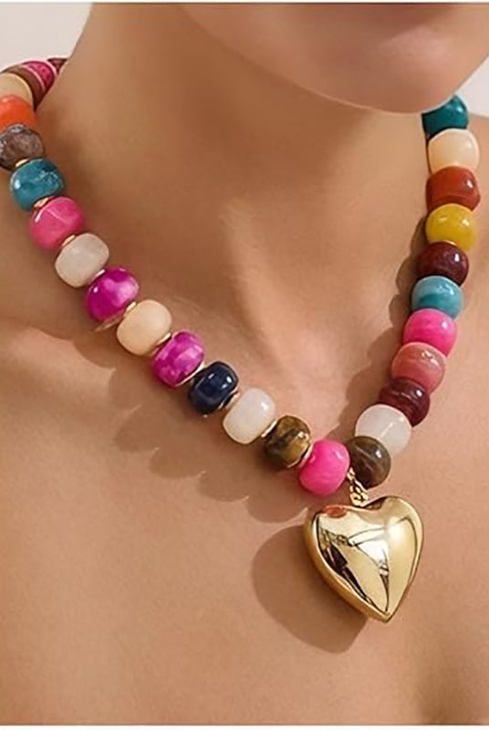 Colorful beaded necklace with a gold heart pendant on a person's neck.