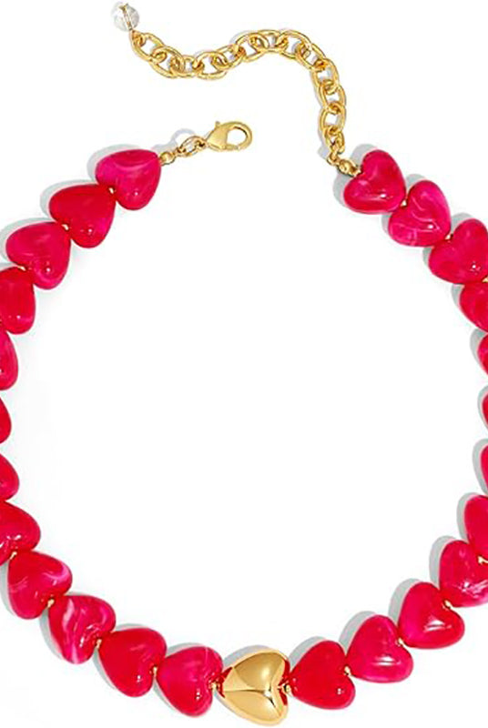 A heart-shaped beaded necklace featuring glossy hot pink heart beads with a central gold heart pendant and a gold chain extender clasp, shown on a plain white background.