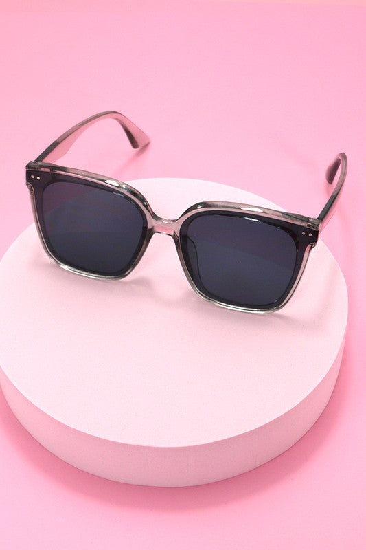 Sunglasses on a pink stand with a pink background