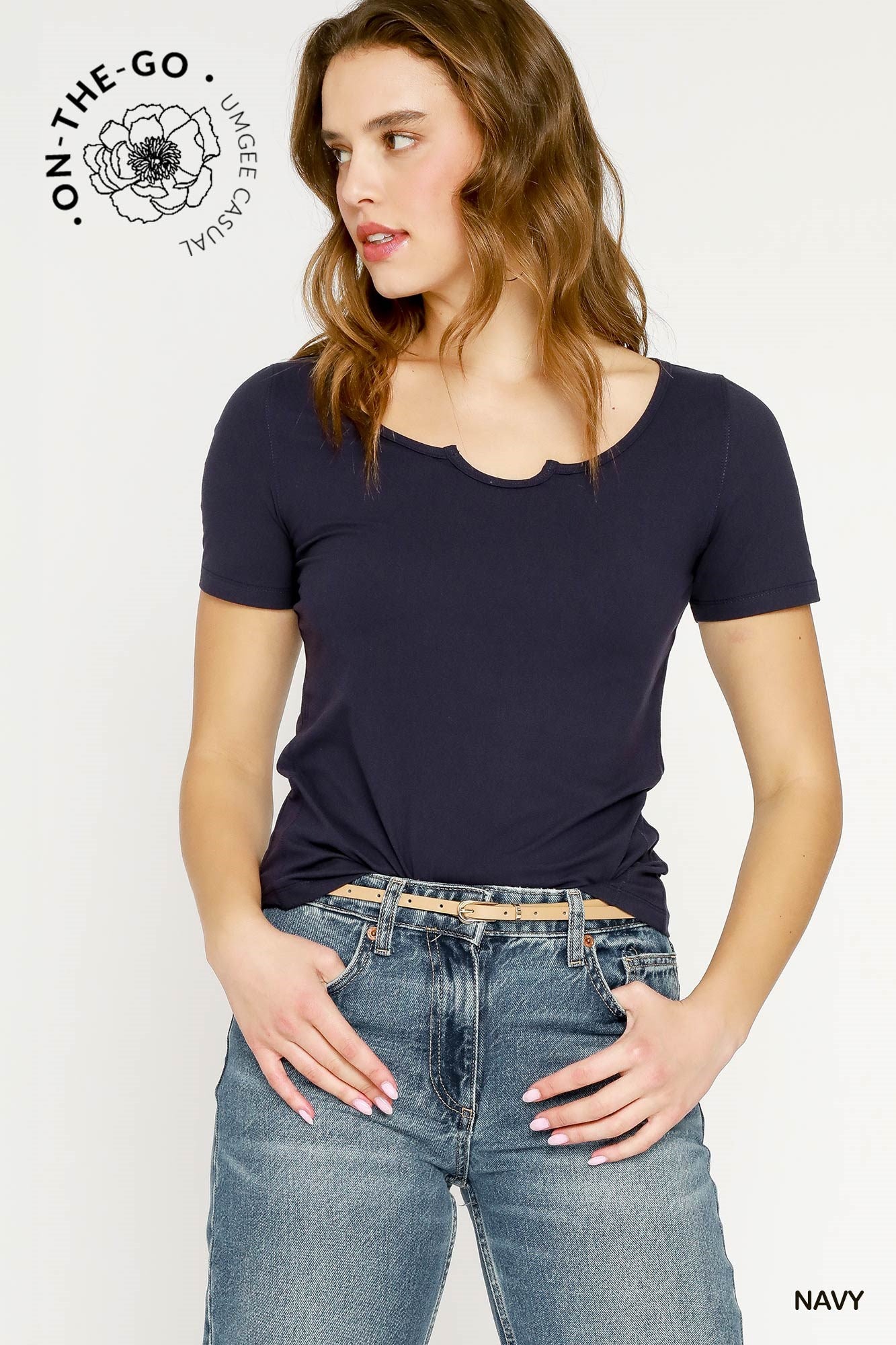 Woman wearing a navy blue t-shirt and blue jeans on a white background with 'On-The-Go' branding.