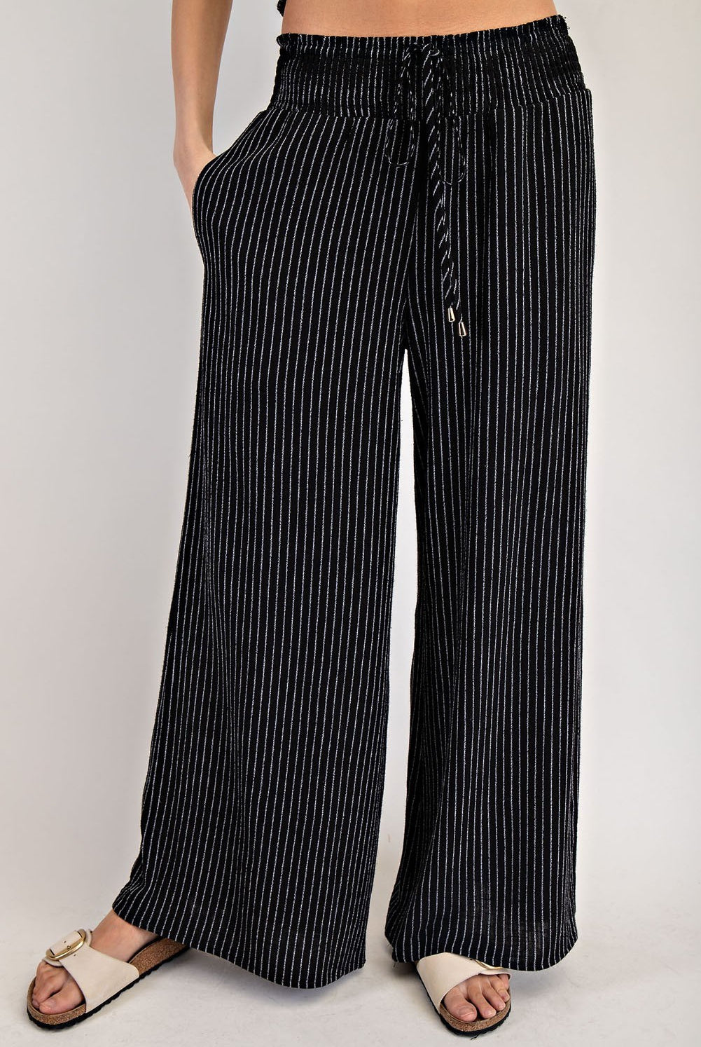 Black pinstripe straight-leg pants, back view
