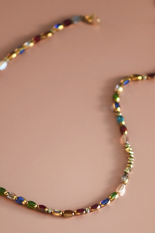Multicolored beaded necklace on a beige background