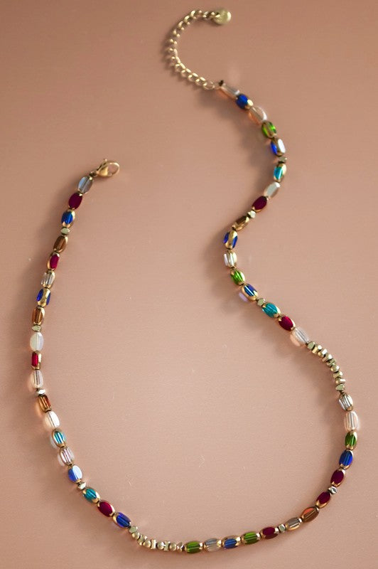 Multicolored beaded necklace on a beige background