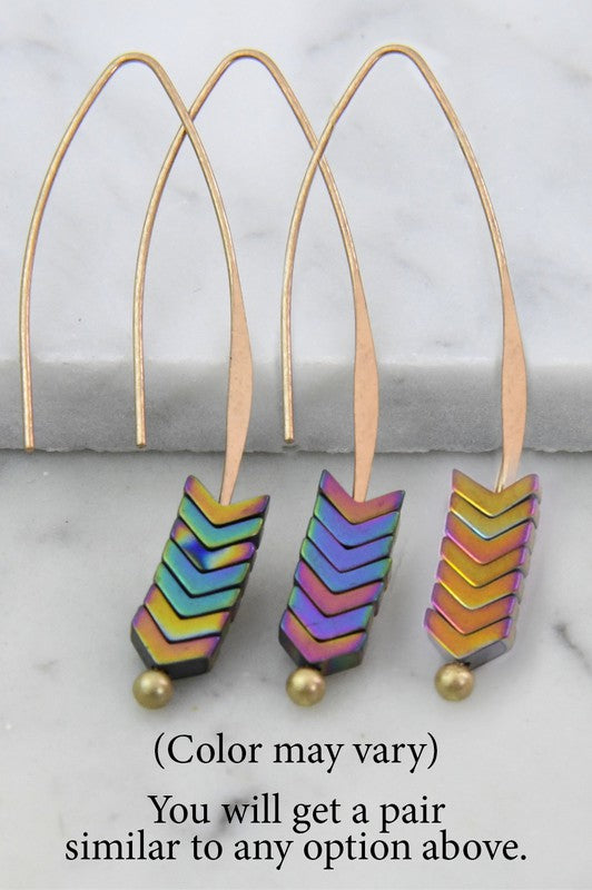 Colorful chevron-patterned earrings on a marble surface with text indicating color variation.