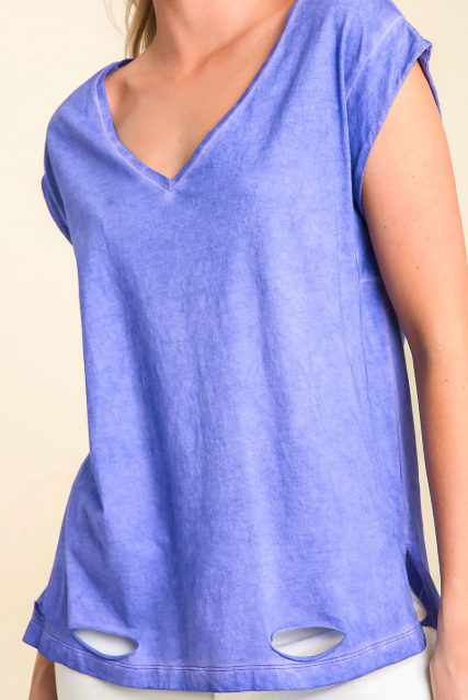 Blue sleeveless top with cut-out details on a beige background