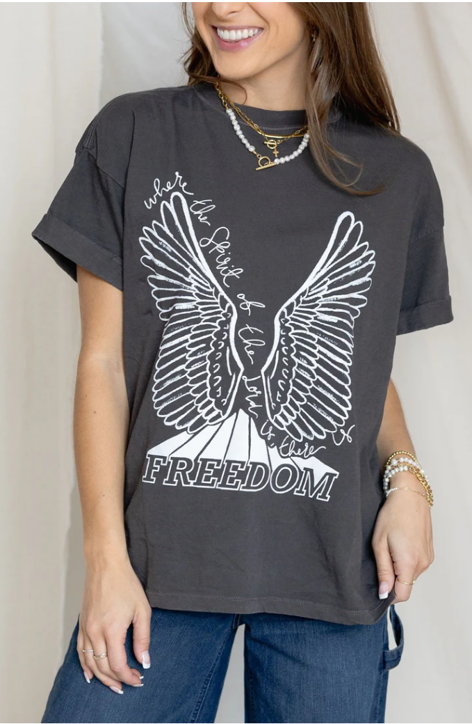 Person wearing a dark gray t-shirt with a white eagle design and 'Where the Spirit of Freedom Flies' text.