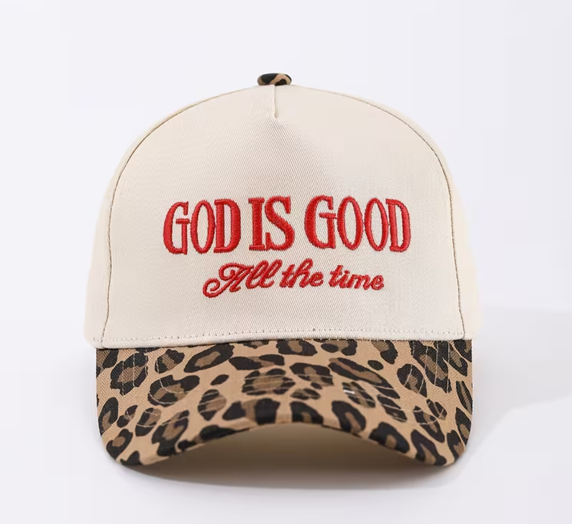 Cap with 'God is Good All the time' text and leopard print brim on a white background