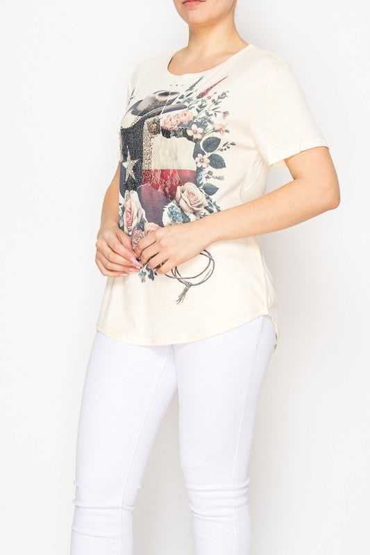 Woman wearing a cream-colored t-shirt with a graphic design on a white background