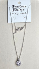Necklace with a teardrop pendant on a card labeled 'Mainstream Boutique' against a beige background