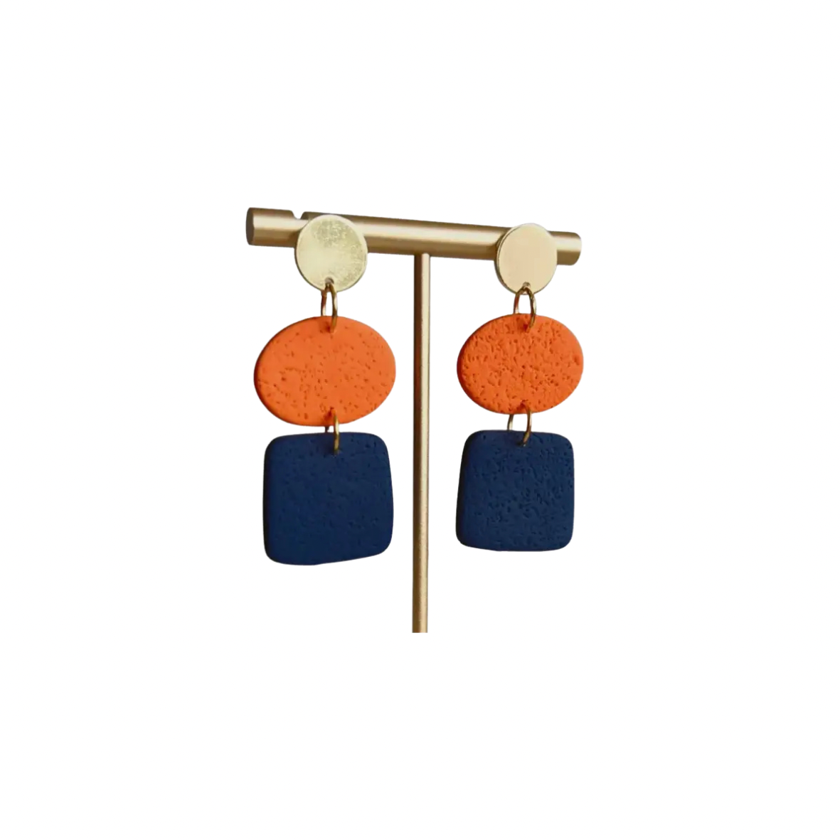 Pair of earrings with orange and blue circular and square pendants on a white background