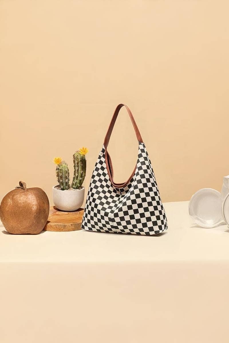 Checkered handbag on a beige surface with decorative items