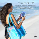 Woman using a touchscreen pouch on a beach with text overlay.