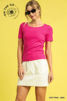 Woman wearing a pink shirt and white skirt on a yellow background with 'On-The-Go' branding.