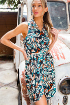 Woman in a patterned dress standing next to an old vehicle
