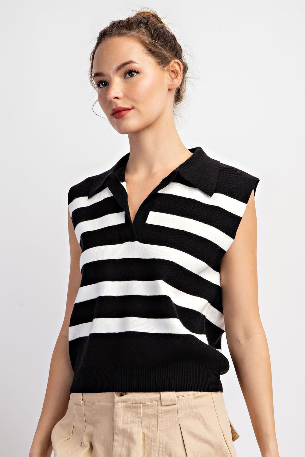 Black and white striped collared sleeveless knit top, angled view