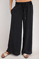 Black pinstripe straight-leg pants, back view