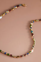Multicolored beaded necklace on a beige background
