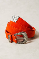 Orange belt with silver buckles on a light gray background