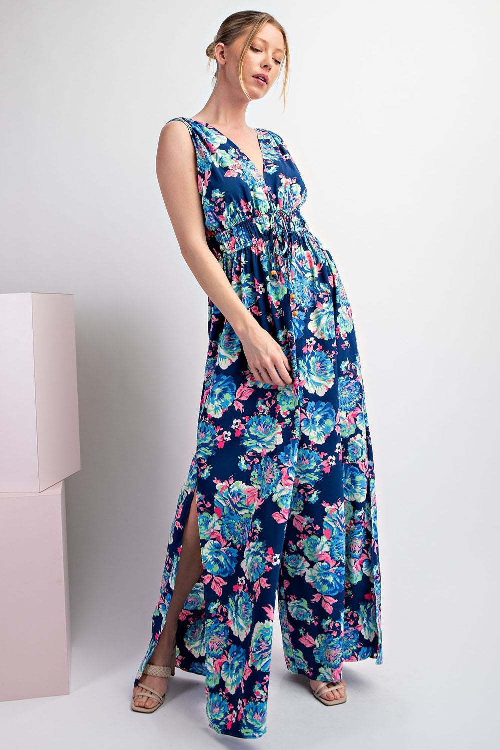 Woman wearing a blue floral dress on a white background