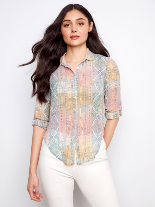 Woman wearing a patterned shirt with a white background