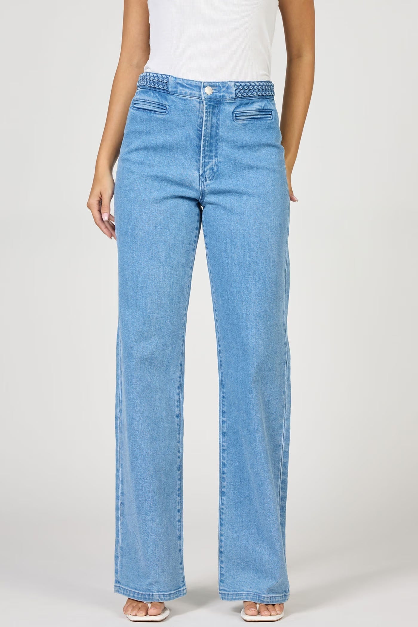 Light blue jeans worn by a person on a white background