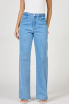 Light blue jeans worn by a person on a white background
