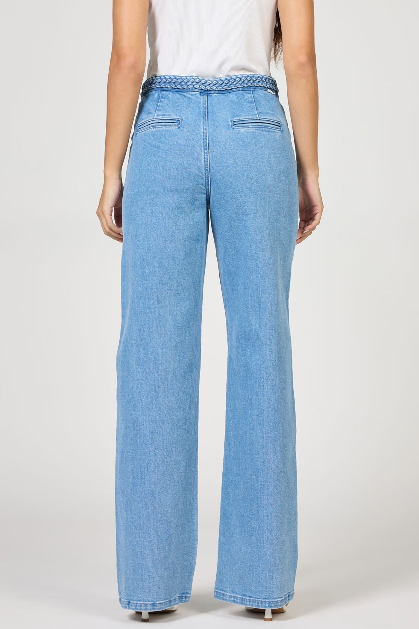 Light blue jeans worn by a person on a white background