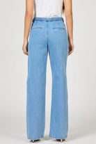 Light blue jeans worn by a person on a white background