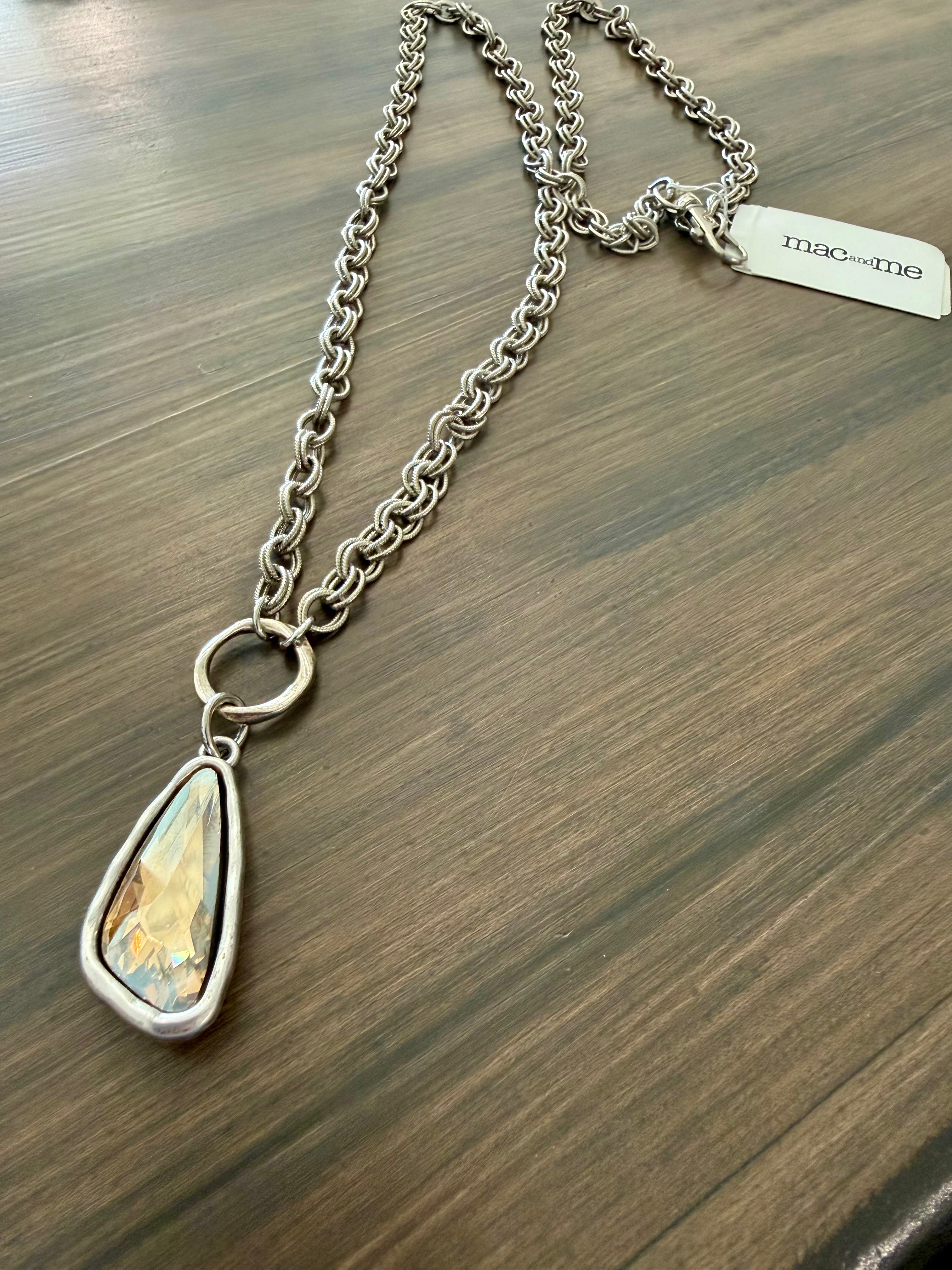 Necklace with a teardrop-shaped pendant on a wooden surface
