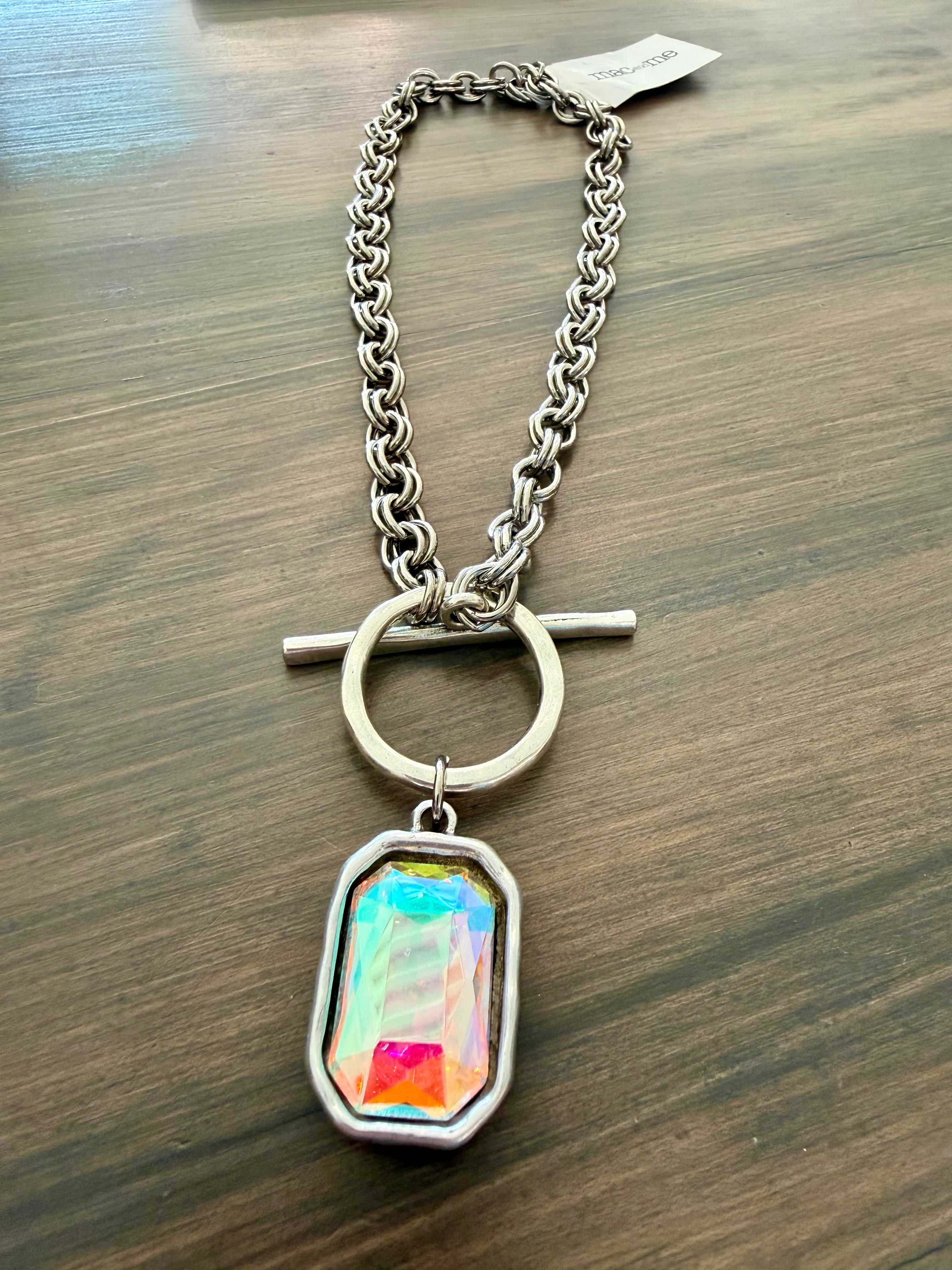 Necklace with a colorful pendant on a wooden surface