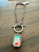 Necklace with a colorful pendant on a wooden surface