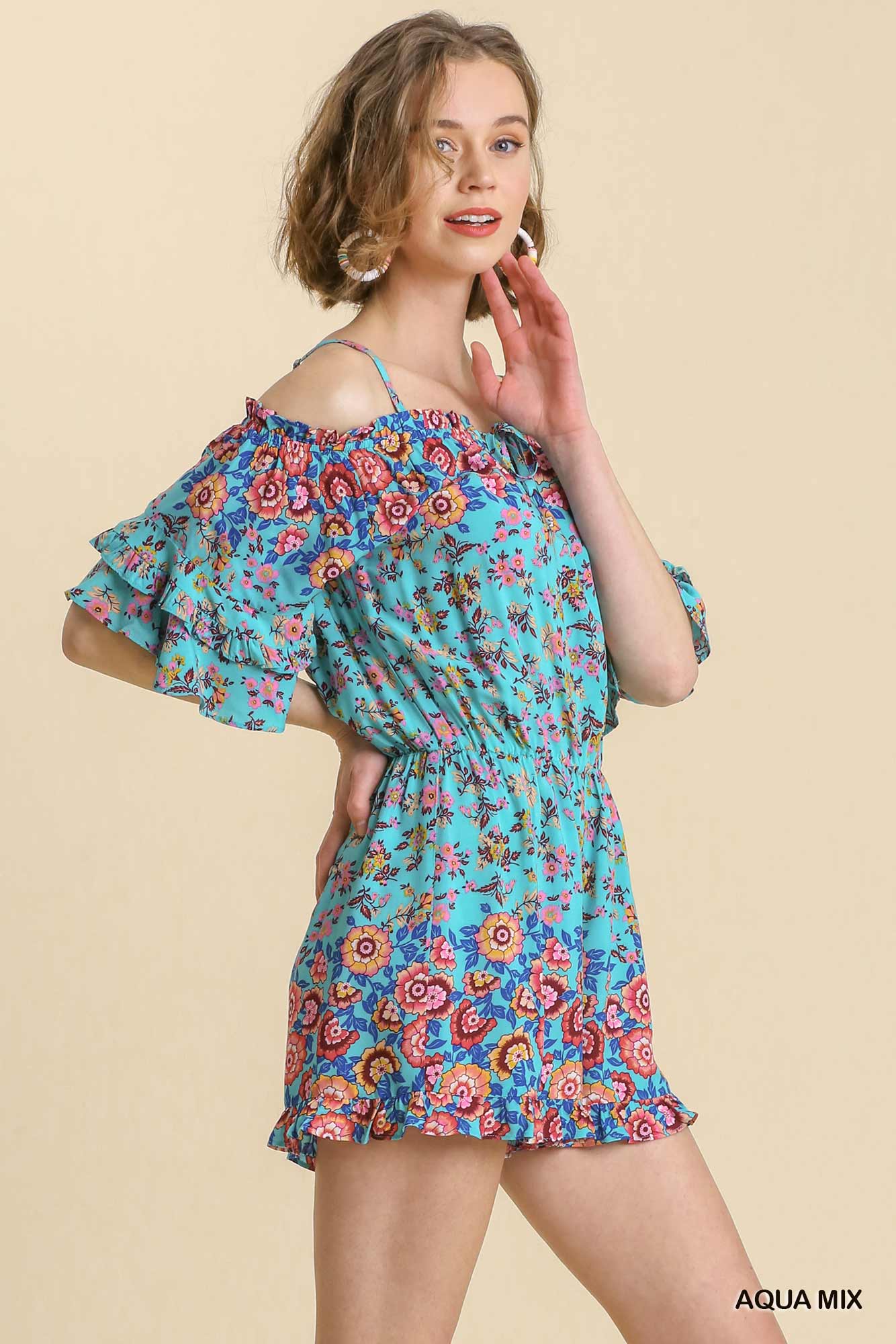 Woman wearing a floral off-shoulder dress on a beige background