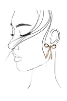 Line art of a woman's face with a detailed earring on a white background