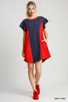 Woman wearing a navy and red dress on a white background