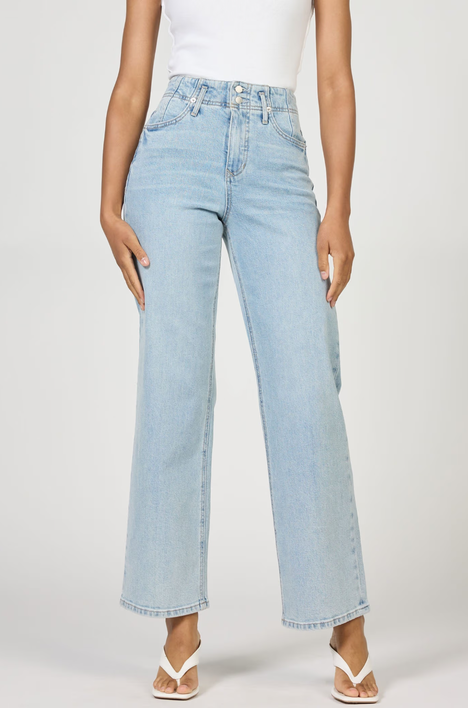 Light blue jeans worn by a person on a white background