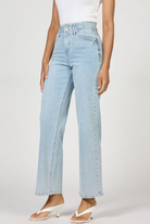 Light blue jeans worn by a person on a plain background