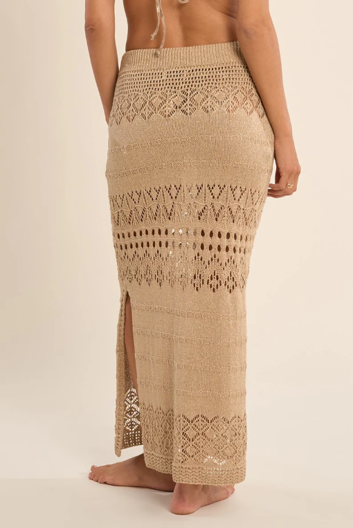 Gold crochet skirt with a slit on a beige background
