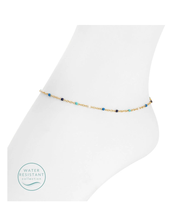 Ankle bracelet with blue and gold beads on a white background