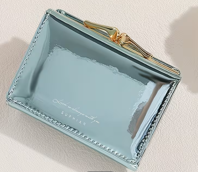 Light blue clutch with gold accents on a light beige background