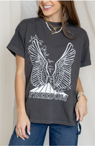 Person wearing a dark gray t-shirt with a white eagle design and 'Where the Spirit of Freedom Flies' text.