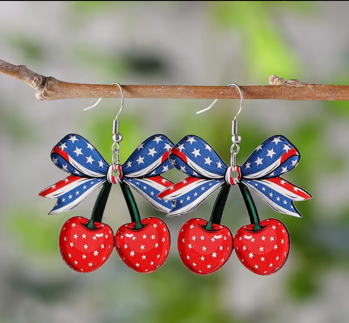Cherry-themed earrings with American flag design on a branch