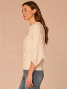 Front view of cream grid stitch dolman sleeve sweater