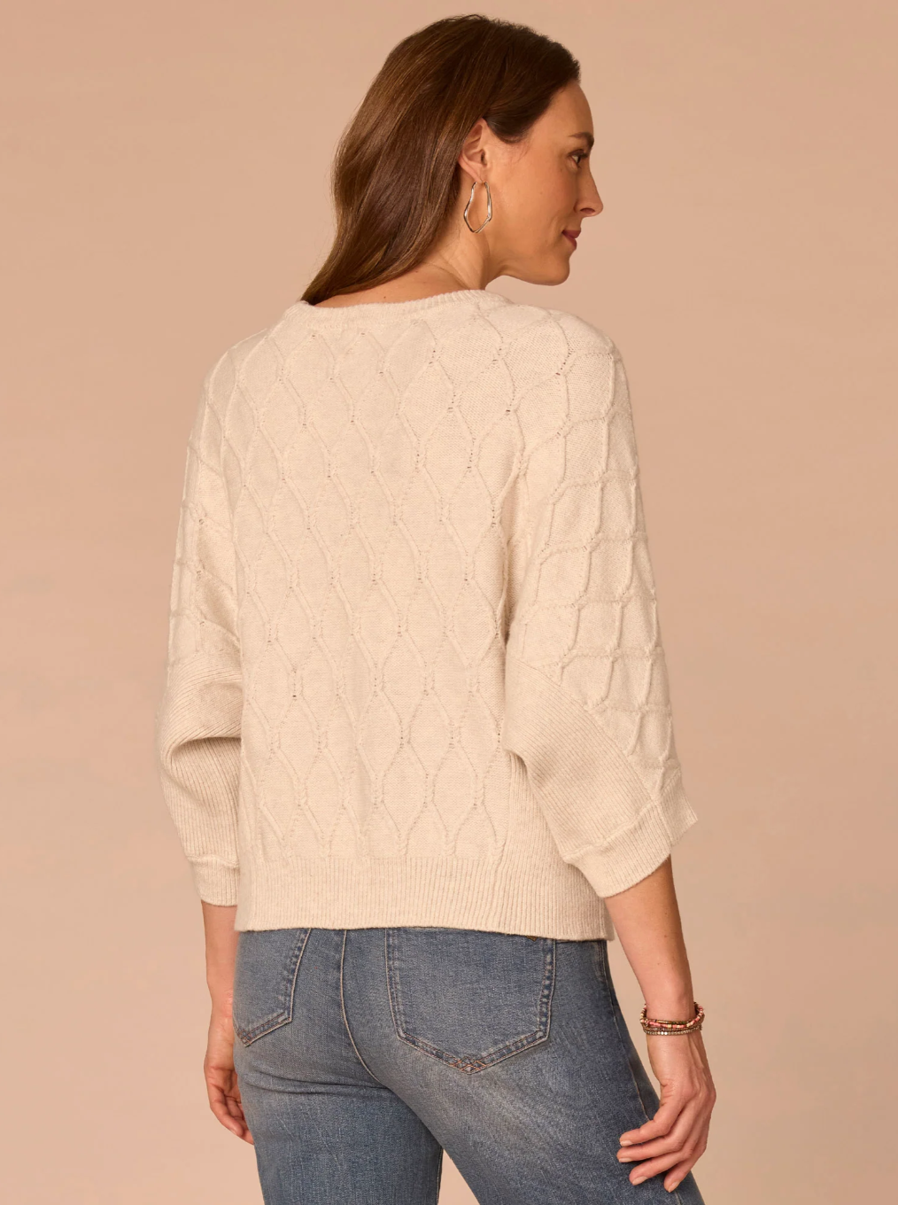 Back view of cream grid stitch sweater