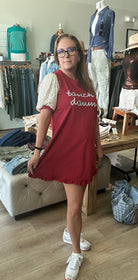 Woman wearing a red dress with text in a clothing store