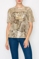 Person wearing a gold sequin t-shirt with text and blue jeans on a white background