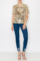 Person wearing a gold sequin top and blue jeans on a white background