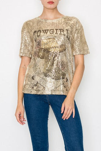 Person wearing a gold sequin top and blue jeans on a white background