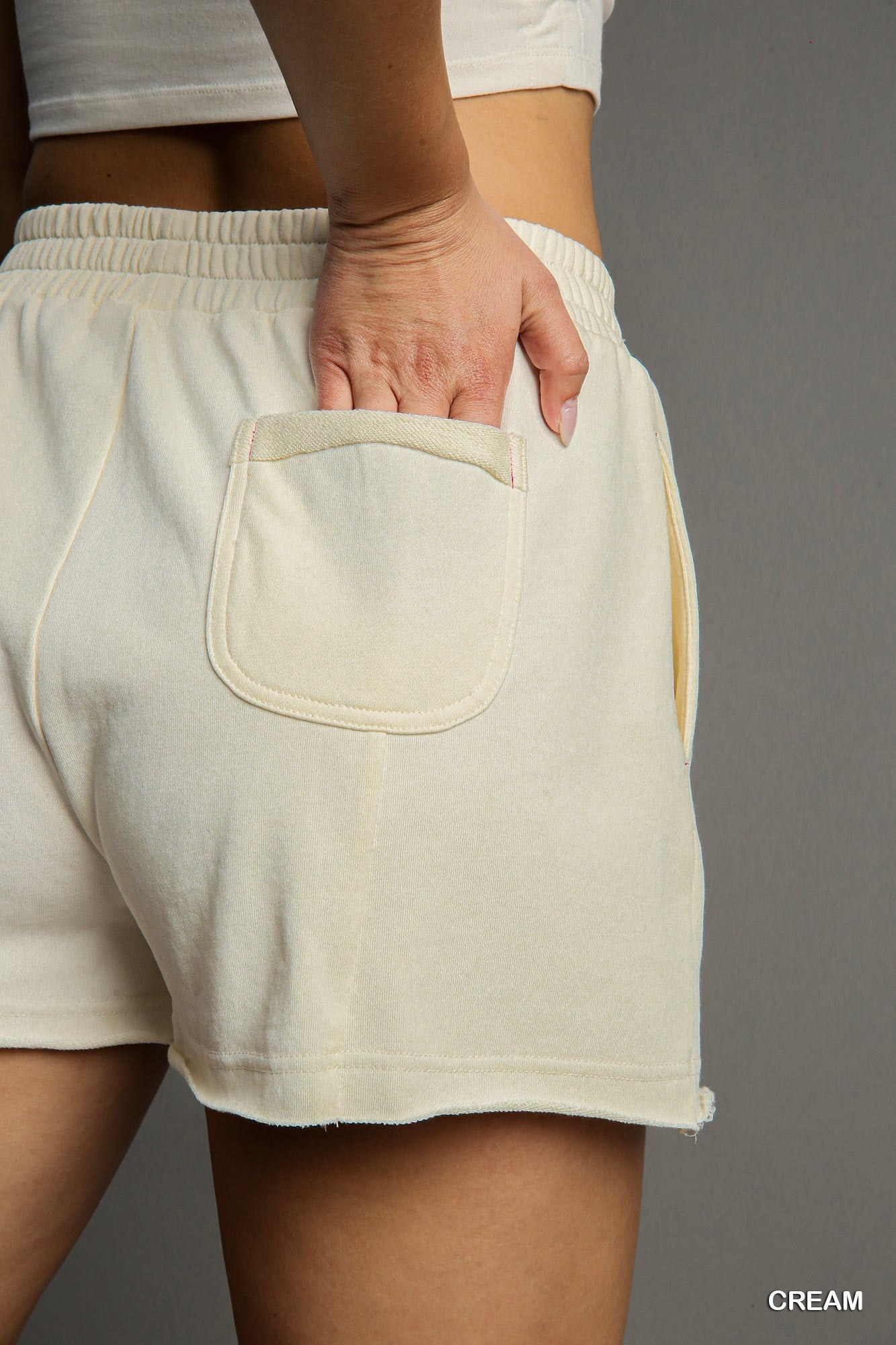 Beige shorts with a pocket on a gray background