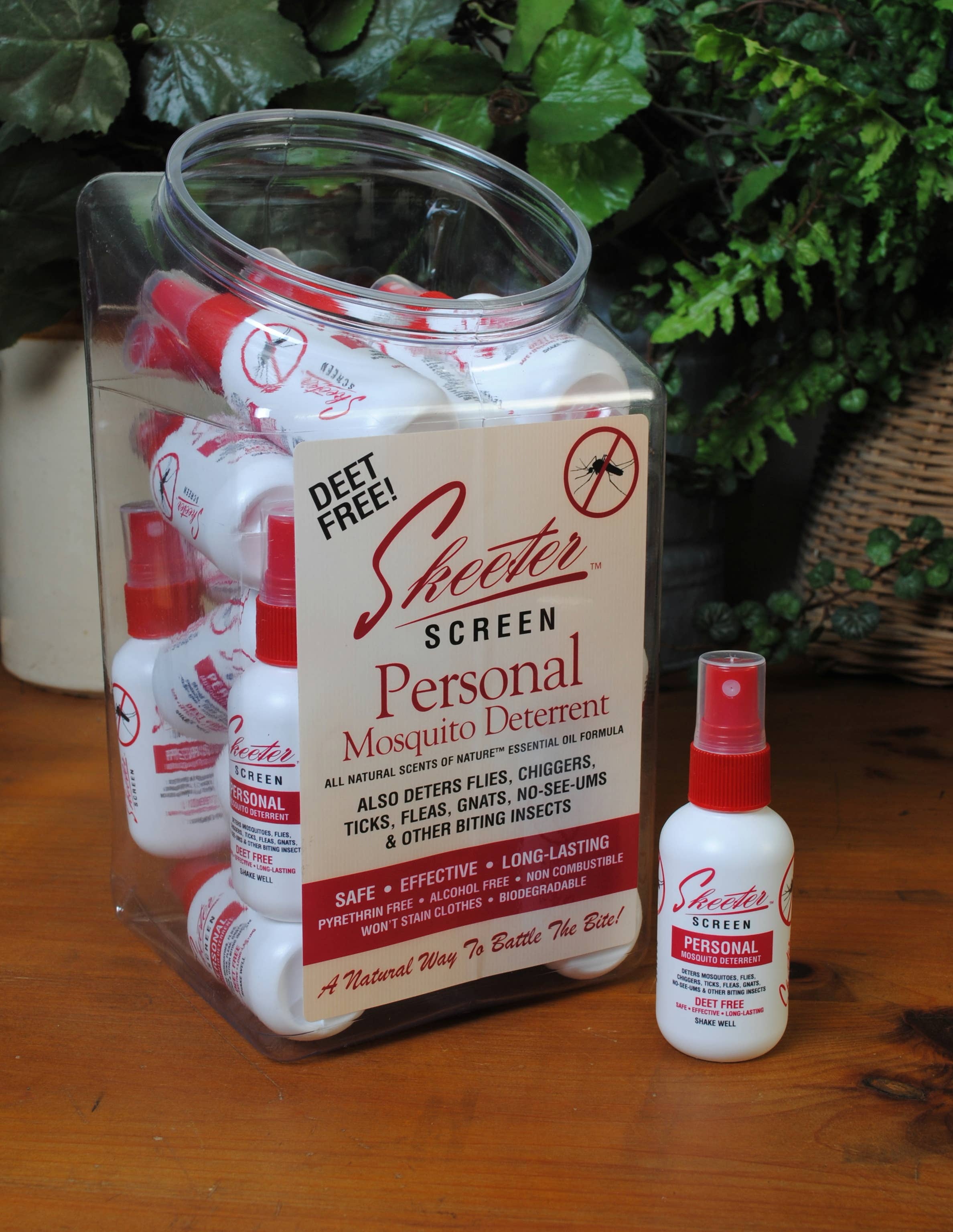 Sheeter Screen Personal Mosquito Deterrent packaging and bottles on a wooden surface with greenery in the background.